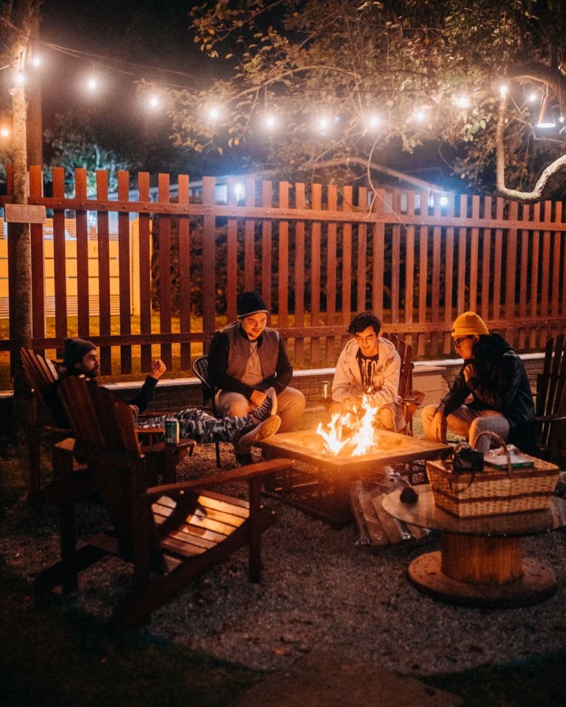 friends sitting together near fire